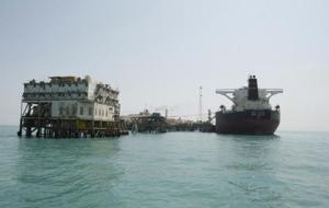 A crane and vessels are seen at the Al-Basra terminal in southern Iraq. Photo courtesy of Reuters.