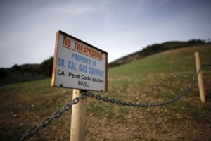 A gas company sign marks a fence near the site of the Aliso Canyon storage field where gas has been leaking in Porter Ranch, California, United States, January 21, 2016. Source: Reuters